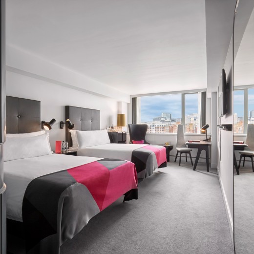 River View Deluxe Double Double hotel rooms feature twin double beds positioned overlooking the Thames, with unparalleled views of London from the wall-to-wall windows