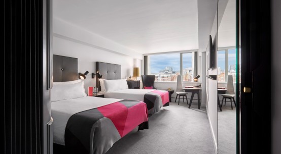 River View Deluxe Double Double hotel rooms feature twin double beds positioned overlooking the Thames, with unparalleled views of London from the wall-to-wall windows